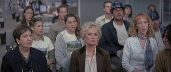 Movie still from “I Heart Huckabees” (2004), directed by David O. Russell – A group of people sitting in front of each other in a room; Medium shot, Over the shoulder angle