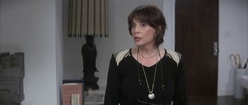 Movie still from “I Heart Huckabees” (2004), directed by David O. Russell – A woman wearing a black and white top and a necklace; Close Up shot, Over the shoulder angle