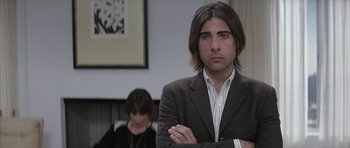 Movie still from “I Heart Huckabees” (2004), directed by David O. Russell – A man in a suit and a woman in a black and white dress; Close Up shot, Over the shoulder angle