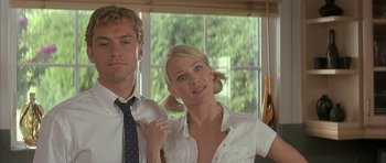 Movie still from “I Heart Huckabees” (2004), directed by David O. Russell – A man and a woman standing next to each other in front of a window; Close Up shot, Low angle