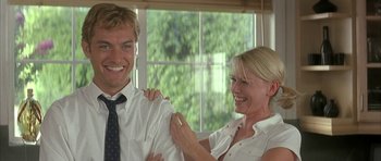 Movie still from “I Heart Huckabees” (2004), directed by David O. Russell – A man and a woman smiling for the camera; Medium shot, Low angle