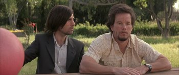 Movie still from “I Heart Huckabees” (2004), directed by David O. Russell – Two men sitting next to each other on a table; Medium shot, Over the shoulder angle