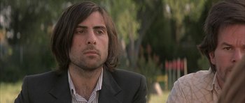 Movie still from “I Heart Huckabees” (2004), directed by David O. Russell – A person wearing a suit and tie; Close Up shot, Low angle