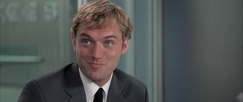 Movie still from “I Heart Huckabees” (2004), directed by David O. Russell – A person wearing a suit and tie; Close Up shot, Over the shoulder angle