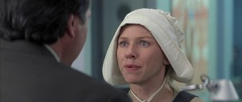 Movie still from “I Heart Huckabees” (2004), directed by David O. Russell – A woman wearing a white hat looking at a man; Close Up shot, Over the shoulder angle