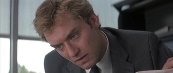 Movie still from “I Heart Huckabees” (2004), directed by David O. Russell – A person wearing a suit and tie; Close Up shot, Low angle