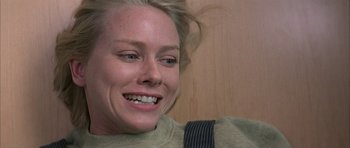 Movie still from “I Heart Huckabees” (2004), directed by David O. Russell – A person smiling with her hair flying in the wind; Close Up shot, Over the shoulder angle