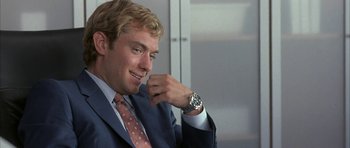 Movie still from “I Heart Huckabees” (2004), directed by David O. Russell – A person wearing a suit and tie; Close Up shot, Over the shoulder angle