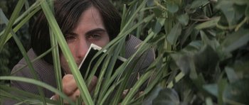 Movie still from “I Heart Huckabees” (2004), directed by David O. Russell – A man holding a cell phone in his hands; Close Up shot, High angle