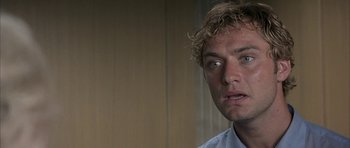 Movie still from “I Heart Huckabees” (2004), directed by David O. Russell – A person wearing a white shirt; Close Up shot, Over the shoulder angle