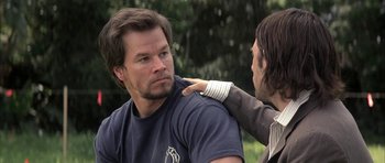 Movie still from “I Heart Huckabees” (2004), directed by David O. Russell – A man with his arm around another mans shoulder; Close Up shot, Over the shoulder angle