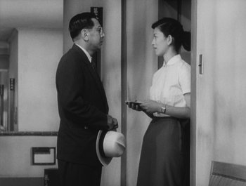 Movie still from “I Live in Fear” (1955), directed by Akira Kurosawa – A man and a woman standing next to each other; Medium shot, Low angle