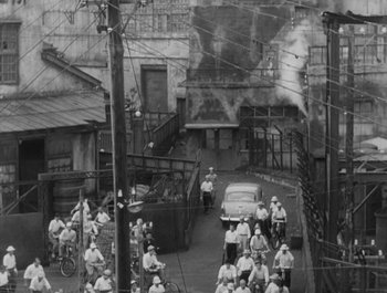 Movie still from “I Live in Fear” (1955), directed by Akira Kurosawa – A group of people standing around a street; Extreme Wide shot, High angle