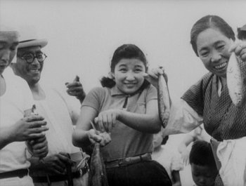 Movie still from “I Live in Fear” (1955), directed by Akira Kurosawa – An old black and white photo of three people; Medium shot, Low angle