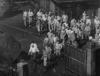 Movie still from “I Live in Fear” (1955), directed by Akira Kurosawa – A group of people walking down a street; Extreme Wide shot, High angle