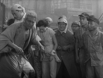 Movie still from “I Live in Fear” (1955), directed by Akira Kurosawa – A group of people standing next to each other; Wide shot, High angle