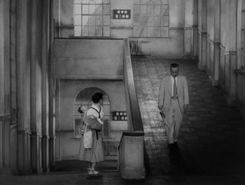 Movie still from “I Live in Fear” (1955), directed by Akira Kurosawa – A man and a woman walking down a set of stairs; Extreme Wide shot, High angle