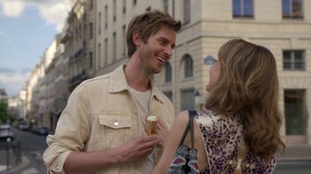 Movie still from “Emily in Paris” (2020), created by Darren Star – A man and a woman are talking to each other; Close Up shot, Over the shoulder angle
