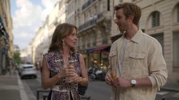 Movie still from “Emily in Paris” (2020), created by Darren Star – A woman and a man are standing on the sidewalk; Medium shot, Over the shoulder angle