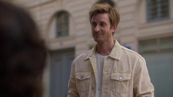 Movie still from “Emily in Paris” (2020), created by Darren Star – A person wearing a jacket; Close Up shot, Over the shoulder angle