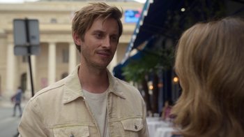 Movie still from “Emily in Paris” (2020), created by Darren Star – A man in a tan jacket talking to a woman; Close Up shot, Over the shoulder angle