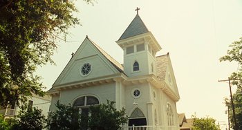 Movie still from “I Love You Phillip Morris” (2009), directed by John Requa – A large white church with a steeple on top of it's steeple; Extreme Wide shot, Low angle