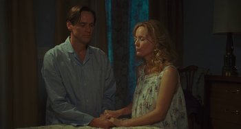 Movie still from “I Love You Phillip Morris” (2009), directed by John Requa – A man and a woman holding hands in a room; Medium shot, Low angle