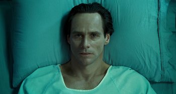 Movie still from “I Love You Phillip Morris” (2009), directed by John Requa – A person laying in a hospital bed; Close Up shot, Overhead angle