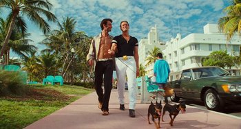 Movie still from “I Love You Phillip Morris” (2009), directed by John Requa – A couple of men walking a dog down a sidewalk; Wide shot, Low angle