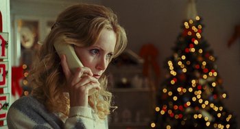 Movie still from “I Love You Phillip Morris” (2009), directed by John Requa – A woman is talking on a phone in front of a christmas tree; Close Up shot, Low angle