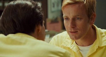 Movie still from “I Love You Phillip Morris” (2009), directed by John Requa – A man in a yellow shirt talking to another man in a yellow shirt; Close Up shot, Over the shoulder angle