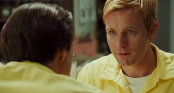 Movie still from “I Love You Phillip Morris” (2009), directed by John Requa – A man in a yellow shirt is talking to another man; Close Up shot, Over the shoulder angle