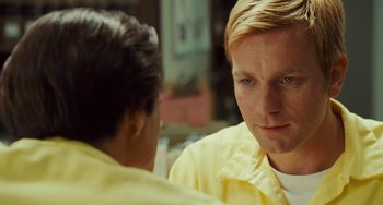 Movie still from “I Love You Phillip Morris” (2009), directed by John Requa – A man with blonde hair and blue eyes talking to another man; Close Up shot, Over the shoulder angle