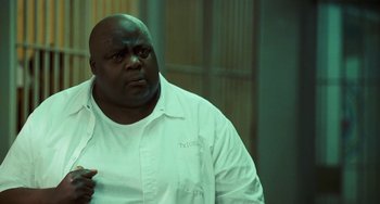 Movie still from “I Love You Phillip Morris” (2009), directed by John Requa – A man in a white lab coat is standing in front of a wall; Close Up shot, Low angle