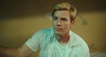 Movie still from “I Love You Phillip Morris” (2009), directed by John Requa – A man with blonde hair wearing a white shirt looking at the camera; Close Up shot, Low angle