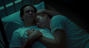 Movie still from “I Love You Phillip Morris” (2009), directed by John Requa – A couple of men laying in a bed next to each other; Close Up shot, Overhead angle