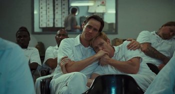 Movie still from “I Love You Phillip Morris” (2009), directed by John Requa – A couple of men sitting next to each other; Medium shot, Low angle