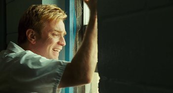 Movie still from “I Love You Phillip Morris” (2009), directed by John Requa – A person looking out a window; Close Up shot, Low angle