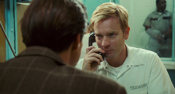 Movie still from “I Love You Phillip Morris” (2009), directed by John Requa – A man is talking on a phone in front of a mirror; Close Up shot, Over the shoulder angle