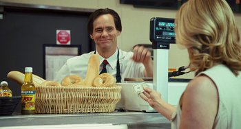 Movie still from “I Love You Phillip Morris” (2009), directed by John Requa – A man in a white shirt and red tie at a counter; Medium shot, Over the shoulder angle