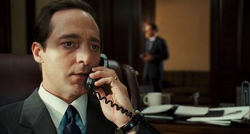 Movie still from “I Love You Phillip Morris” (2009), directed by John Requa – A person talking on a phone; Close Up shot, Over the shoulder angle