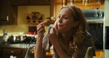 Movie still from “I Love You Phillip Morris” (2009), directed by John Requa – A beautiful woman holding a piece of food in her hand; Close Up shot, High angle