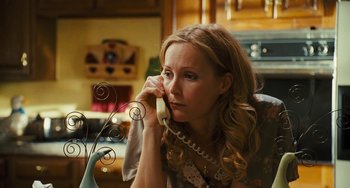 Movie still from “I Love You Phillip Morris” (2009), directed by John Requa – A woman sitting at a table talking on a phone; Close Up shot, High angle