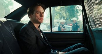 Movie still from “I Love You Phillip Morris” (2009), directed by John Requa – A man sitting in the back seat of a car; Close Up shot, Over the shoulder angle