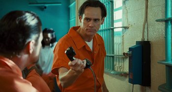 Movie still from “I Love You Phillip Morris” (2009), directed by John Requa – A man holding a video game controller in a jail cell; Close Up shot, Over the shoulder angle