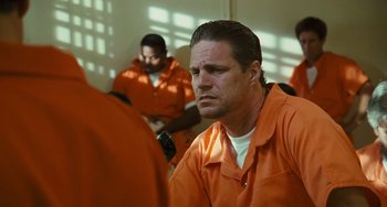Movie still from “I Love You Phillip Morris” (2009), directed by John Requa – A man in an orange jail suit; Close Up shot, Over the shoulder angle