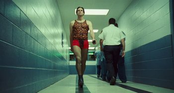 Movie still from “I Love You Phillip Morris” (2009), directed by John Requa – A man walking down a hall way with his legs crossed; Wide shot, Low angle