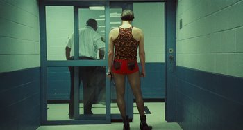 Movie still from “I Love You Phillip Morris” (2009), directed by John Requa – A man in shorts is standing in front of a door; Wide shot, Over the shoulder angle