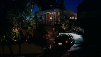 Movie still from “I Love You, Man” (2009), directed by John Hamburg – A car is parked on the side of the road at night; Extreme Wide shot, High angle