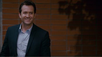 Movie still from “I Love You, Man” (2009), directed by John Hamburg – A man in a suit smiling for the camera; Close Up shot, Over the shoulder angle